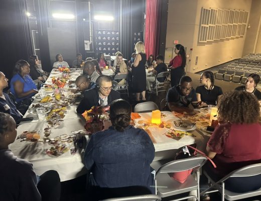 Students enjoy Thanksgiving meal with guests.